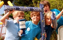 4 boys with Sparks buckets and banners