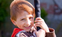 Sam Harwood on a swing. Sam's photo was used on the front of the Annual Review