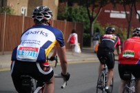 A Sparks RideLondon participant cycles past the supporters
