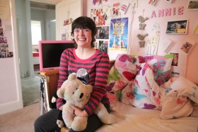 Annie in her bedroom Annie holding a teddy bear in her bedroom