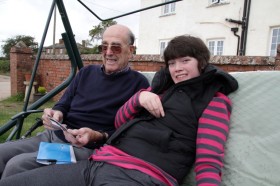 Annie looks at photos with her grandad Annie looks at photos with her grandad
