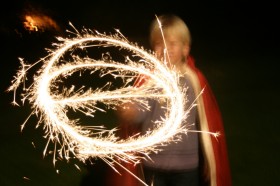 Child waving a sparkler in circuar motion