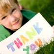 Child holding thank you sign