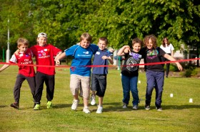 The kids approach the finish line in a three-legged race for Sparks